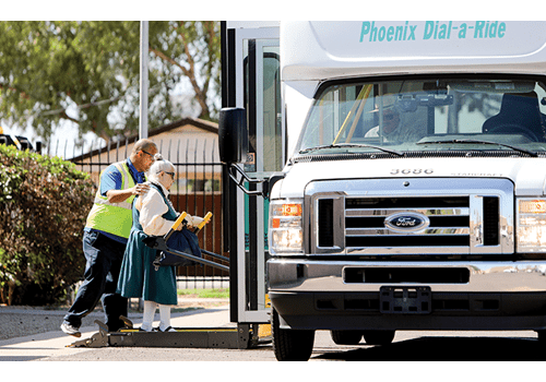 Arizona Center for the Blind & Visually Impaired volunteer helps elderly woman.